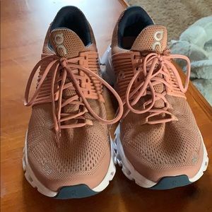 Rose gold on cloud tennis shoe